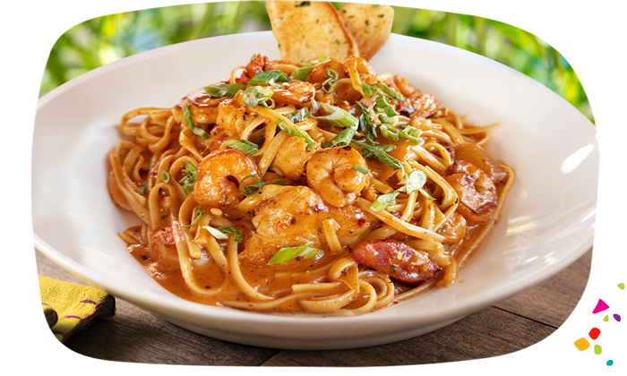 Rasta Pasta with sautéed shrimp, chicken, grilled chorizo, and linguine in spicy red pepper cream sauce