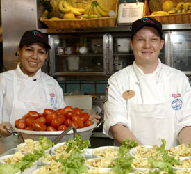 Bahama Breeze Chefs Two Bahama Breeze Chefs smile as they prepare food
