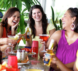 Bahama Breeze Guests Three ladies laugh during a meal at Bahama Breeze